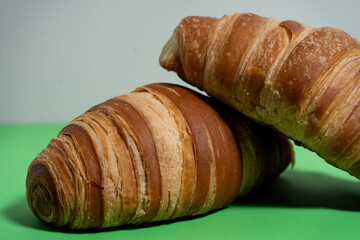 French pastry isolated on bold green surface