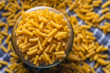 Close up shot of elbow macaroni stored in a glass jar