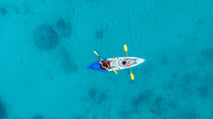 Aerial view of a kayak in the blue sea .man kayaking he does water sports activities