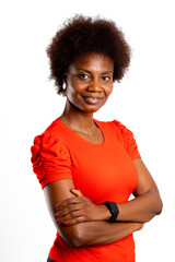 Young latin woman, brunette, arms crossed and smiling, looks at camera against white background