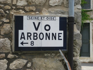 Old road signs indicating the village of Arbonne in enameled lava in France - Vieux panneaux routier indiquant le village d'Arbonne en lave &eacute;maill&eacute;e en France