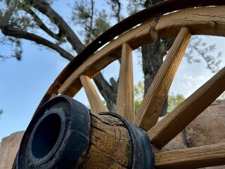 A detailed close-up of a weathered wagon wheel in Rancho Cucamonga, California, evokes a sense of historical transport and rustic charm.