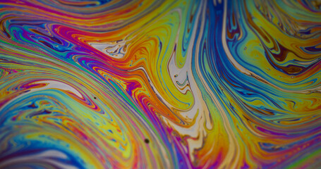 Psychedelic fluid. Oil abstraction. Defocused green purple blue colorful drop ink water texture floating on creative pink yellow background.