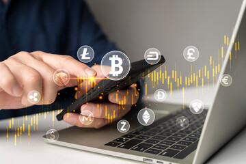 Cryptocurrency trading on smartphone with bitcoin and digital coin icons over candlestick chart and laptop