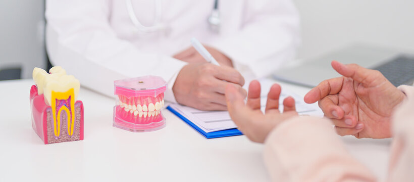 Elderly Patient consulting Dentist to Tooth disease, Senior Health Medical Diagnosis. Anatomy teeth model for Oral Teeth decay, Scrape off tartar. March Oral health, Dentist Day, False Teeth concept