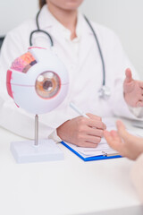 Elderly Patient consulting Doctor to Eye disease, Senior Medical Diagnosis. Anatomy Eye model for...