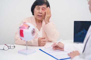 Elderly Patient consulting Doctor to Eye disease, Senior Medical Diagnosis. Anatomy Eye model for...