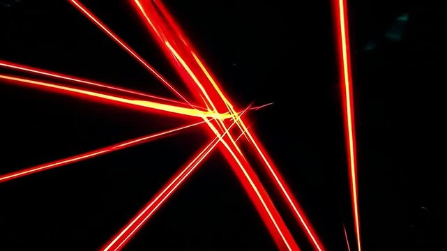 Dynamic Red Laser Beams Cutting Through Dark Background Creating Striking Visual Effects