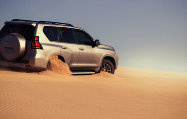 Detailed front view of a car stuck in thick desert sand, emphasizing power, resistance, and the...
