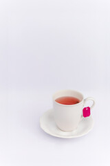 Relaxing concept hot herbal tea in white mug on white background