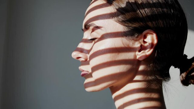 Woman with Striped Shadows on Face in Soft Natural Light