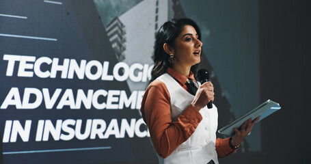 Business woman, presentation or seminar with mic or tablet for speech or convention at workplace....