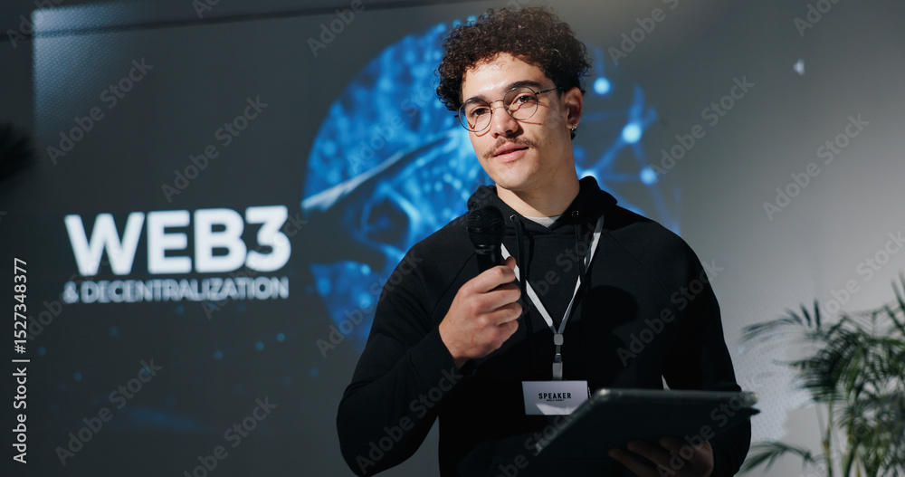 Poster Man, tablet and mic for presentation with web3, decentralization and blockchain by screen for future. Person, speaker and touchscreen with app, innovation and discussion on stage at tech convention