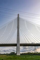 Vertical image of the central pylon of Flintshire Bridge in North Wales, with its symmetrical cable-stayed design spanning across the River Dee