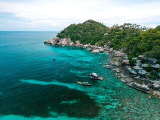 Vibrant Thai Longtail Boat in Turquoise Waters by Tropical Beach and Lush Mountains