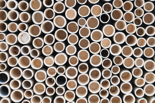 bamboo pile stacked vertically create texture wall background. Circle in front of pipes pattern
