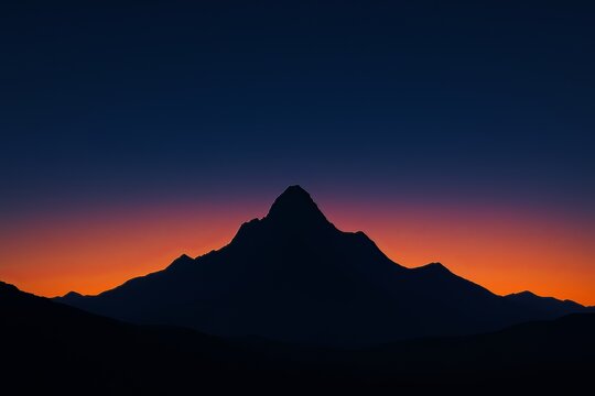 A silhouette of a mountain range against a vibrant sunset with a gradient of colors in the sky