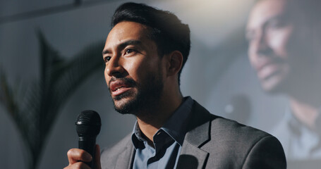 Meeting, training and man with mic, speech or motivational speaker for session, serious and...