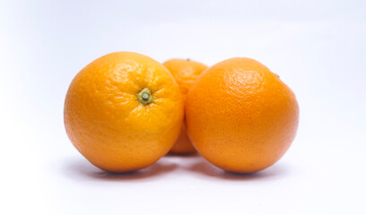 Orange fruits piled up on white background, beautiful texture, delicious. High vitamin C fruit concept.