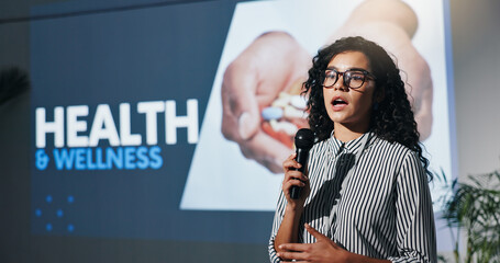 Convention, presentation and business woman with microphone for health, wellness and forum. Conference, speech and workshop with motivational speaker for coaching, lecture and event in auditorium