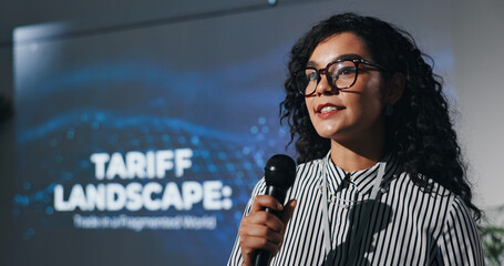 Microphone, seminar and speech with business woman in auditorium for presentation in tariff...