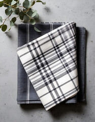 top view of two checkered napkins lying on a light gray surface
