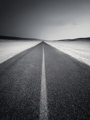 A straight road in the middle of magnificent sand dunes, dramatic photo, simple line drawing, symmetrical composition, at dusk, master of landscape photography, film emulsion fading effect
