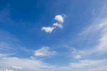 Obraz premium clear blue sky background,clouds with background, Blue sky background with tiny clouds. White fluffy clouds in the blue sky. 