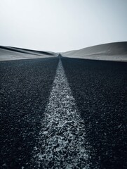 A straight road in the middle of magnificent sand dunes, dramatic photo, simple line drawing, symmetrical composition, at dusk, master of landscape photography, film emulsion fading effect