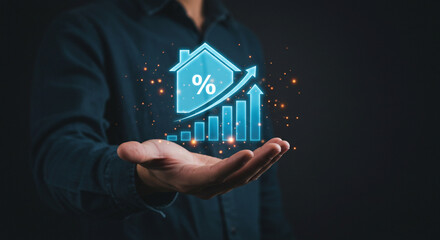 A hand holding a glowing blue house icon with a percentage sign and a rising bar graph with arrows business.selling ,purchasing,agreement 