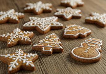 Fototapeta premium Christmas cookies decorated with icing on wooden table presents festive treats