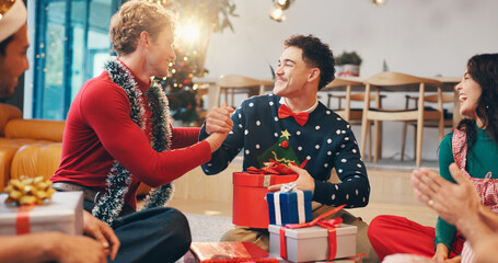 Christmas, gift and thank you with friends at party for love, festive holiday and reunion. Present, support and xmas season with people and handshake in home for box, secret Santa or celebrate