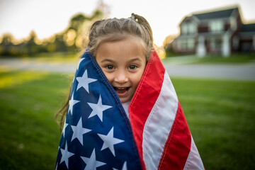 a little girl holding a flag in her hands