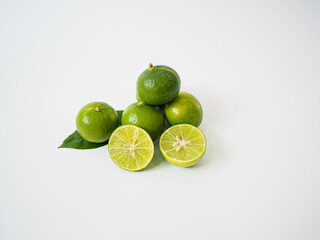 Overhead view of limes arranged naturally with slice exposing inner pulp to create visual interest...