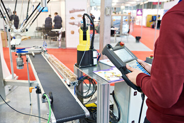 Worker with control panels for manipulators for food production