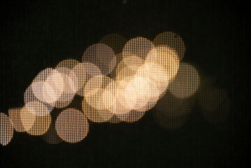 Blurred lights, soft glow, dark background.