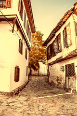 Fototapeta premium Sepia toned vintage effect photo of Sirince village. Traditional houses, narrow streets. Tourist destination in Izmir. 