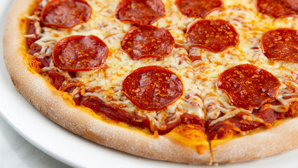 Close-up of Delicious Pepperoni Pizza with Melted Cheese on White Plate, Classic Italian Pizza Slice