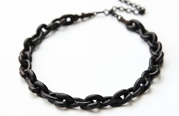 Black necklace on white background. Stylish accessory, metal jewelry. Fashionable necklace, chain necklace. Trendy jewelry design, close-up shot isolated on white.