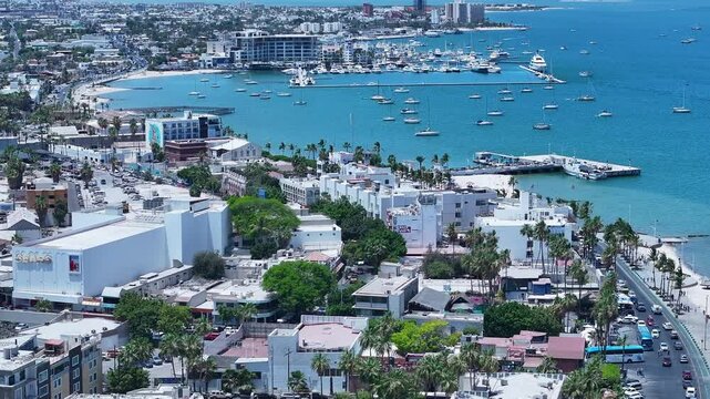 Aerial La Paz Mexico city along ocean bay marina 1 4K. Mexican state of Baja California Sur, peninsula. Ferry service, cargo and cruise ships from port. Eco tourism is source of income. Vacation.