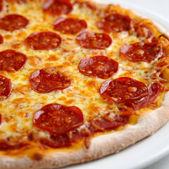 Whole Pepperoni Pizza with Melted Cheese on White Plate, Classic Italian Fast Food and Savory Snack