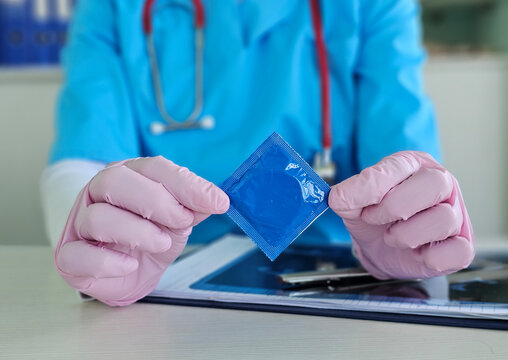Healthcare professional demonstrates condom use with safe sex education materials