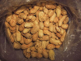 Abundance of Fresh Peanuts in Shell in a Transparent Plastic Bag