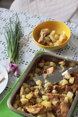 Rustic summer lunch with potatoes outdoors on a lace tablecloth.