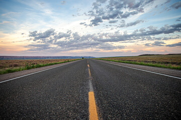 Open road low angle asphalt cloudy sky