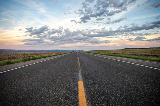 Fototapeta Open road low angle asphalt cloudy sky