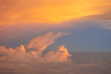 Sunset clouds with golden and violet tones over a twilight sky