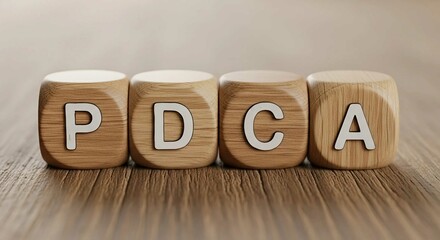 PDCA written on wooden blocks. Plan do check act concept for business process improvement. Quality control and management.