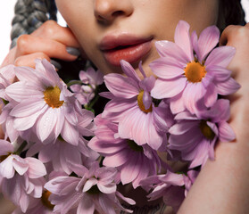 Woman body parts with  medical plaster holds flowers. Closeup face of young beautiful woman with a healthy  skin. Body care and health concept