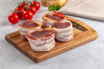 Raw pork tenferloin with bacon